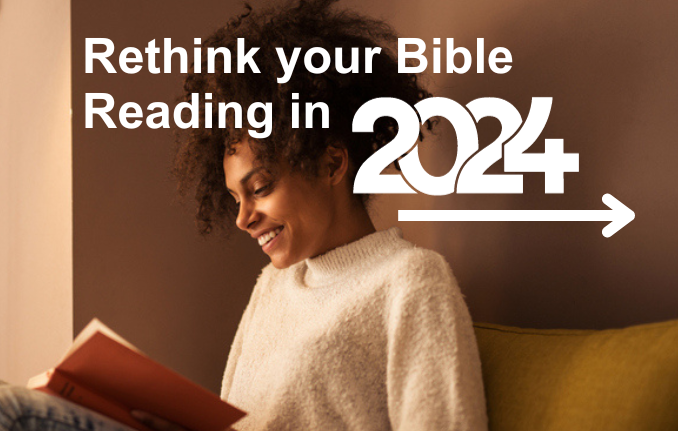 African American woman reading her bible alone smiling