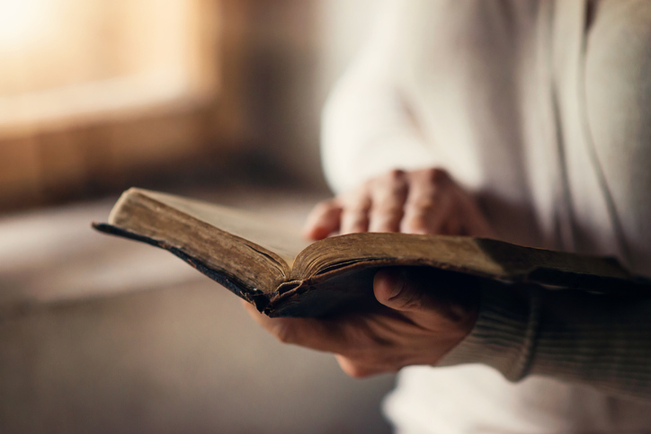 woman holding Bible and reaading