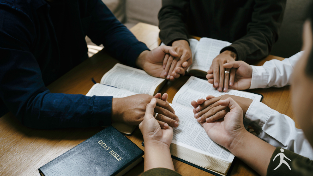 A diverse group of believers praying together in fellowship