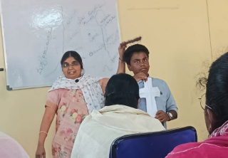 A local ministry leader in India using a handmade crown of thorns crafted from toothpicks