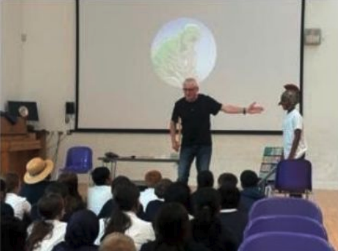 A child in an English public school participating in a biblical lesson with a prop sword